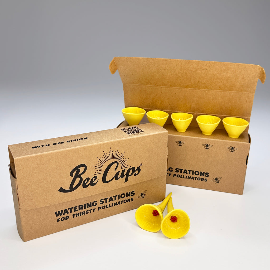 Bee Cups watering stations packaging with yellow cups with red centers on a gray background